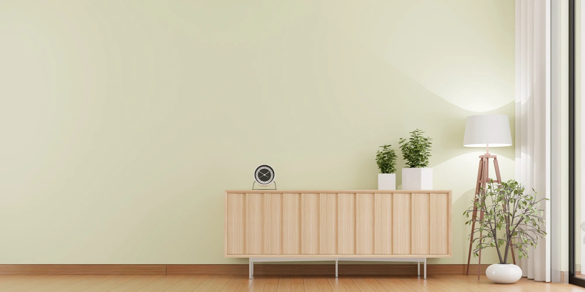 A calm sage living room with a timber sideboard
